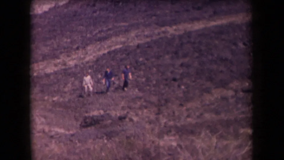 Distant hikers traverse a rocky Arizona mountainside in this soft, grainy 1958 home-movie frame.