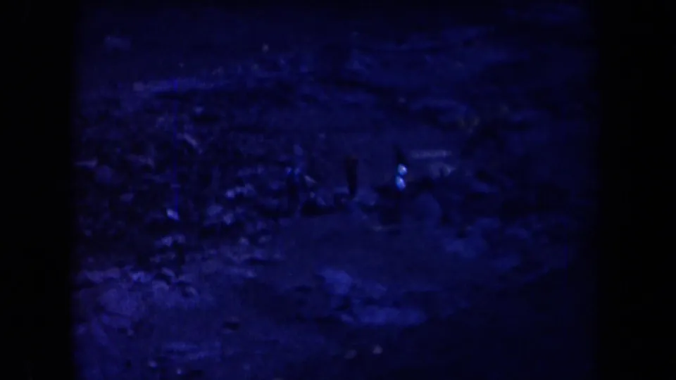 A small distant man moves through shadowed rocky Arizona desert terrain in this 1958 home-movie still.