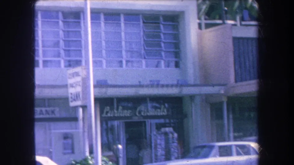 1969 Hawaii street view with Central Pacific Bank at left, Lurline Casuals signage, a parked car, and a foreground street sign.