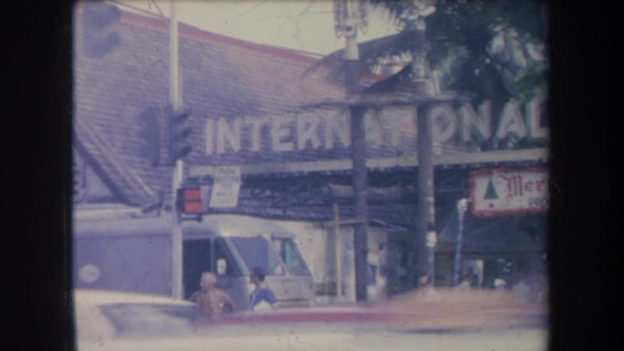 International Market storefront with a white van and pedestrians near the entrance.