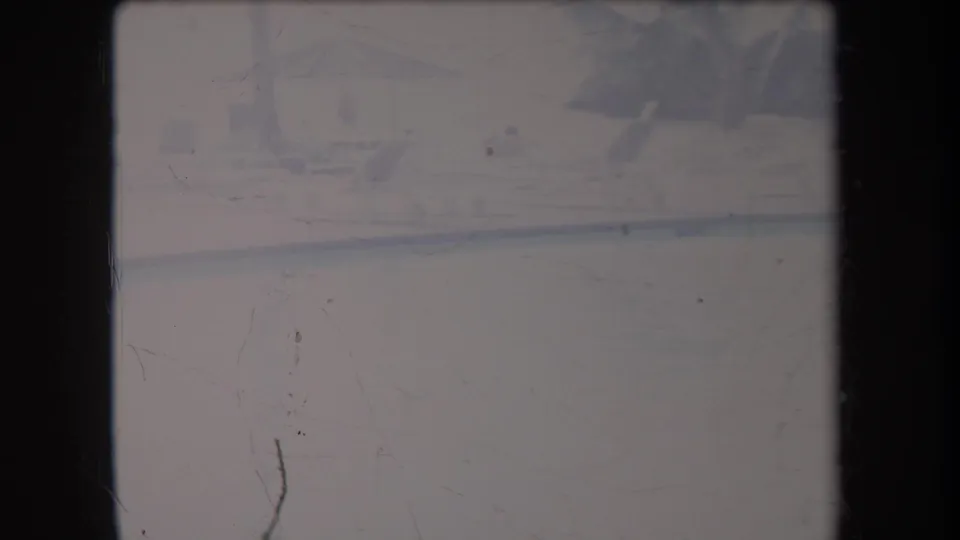 Soft 8mm Hawaii frame showing fog-muted water, a shoreline, and barely visible tropical vegetation.
