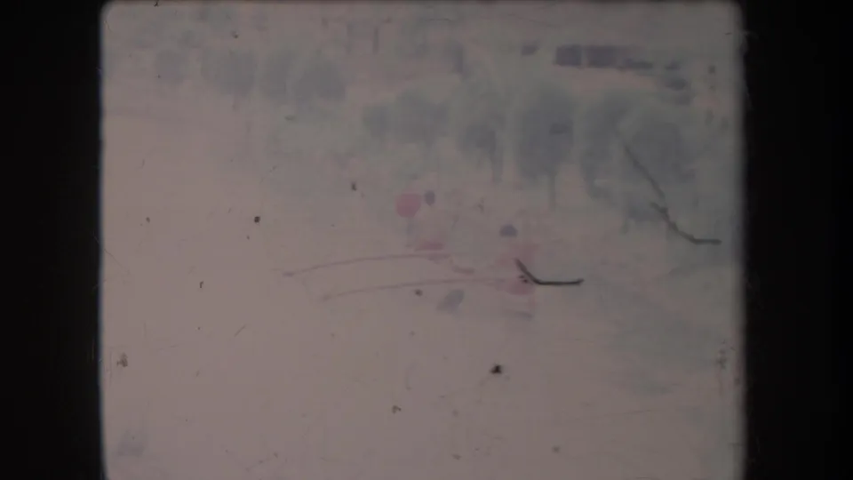 Final 1969 Hawaii home-movie frame showing the canoe scene softened by scratches, faded color, and distance.