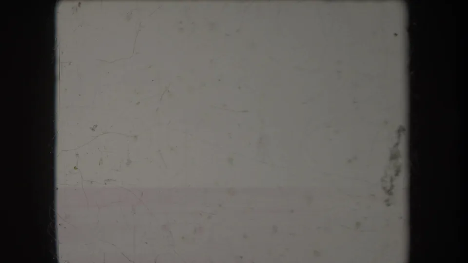 Faded 1969 Hawaii home-movie frame with a distant sea horizon, pale sky, scratches, and dark 8mm gate edges.