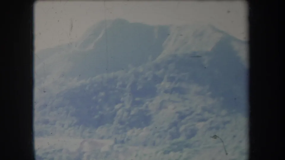 1969 Hawaii 8mm frame with a rounded, tree-covered ridge filling much of the view.
