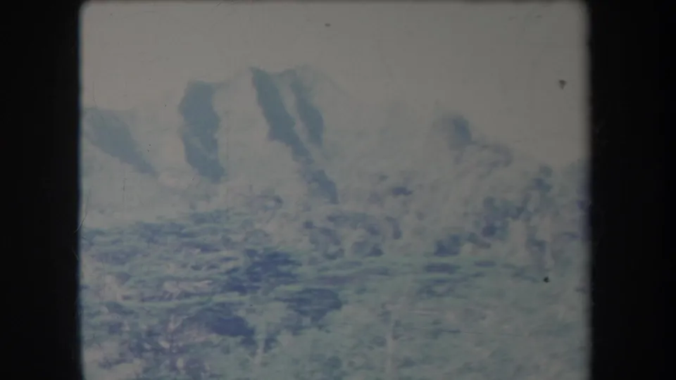 1969 Hawaii 8mm still showing a soft, handheld view of mountains and valley vegetation.