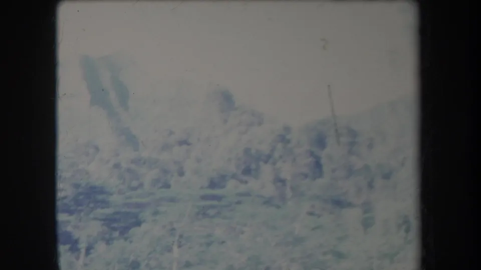 Final 1969 Hawaii landscape frame with distant peaks, valley texture, and pronounced home-movie fading.