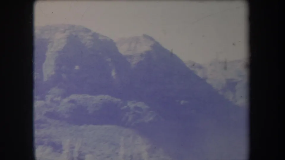 1969 Hawaii 8mm frame with rugged treeless slopes, dark valley shadows, and softened archival film color.