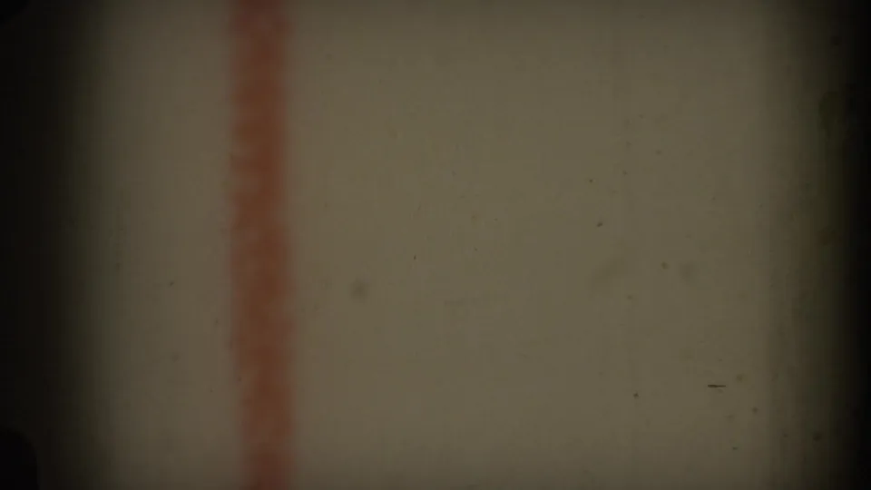 1969 Hawaii 8mm frame showing a close-up of an off-white surface with a soft red vertical stripe and shadowed film edges.
