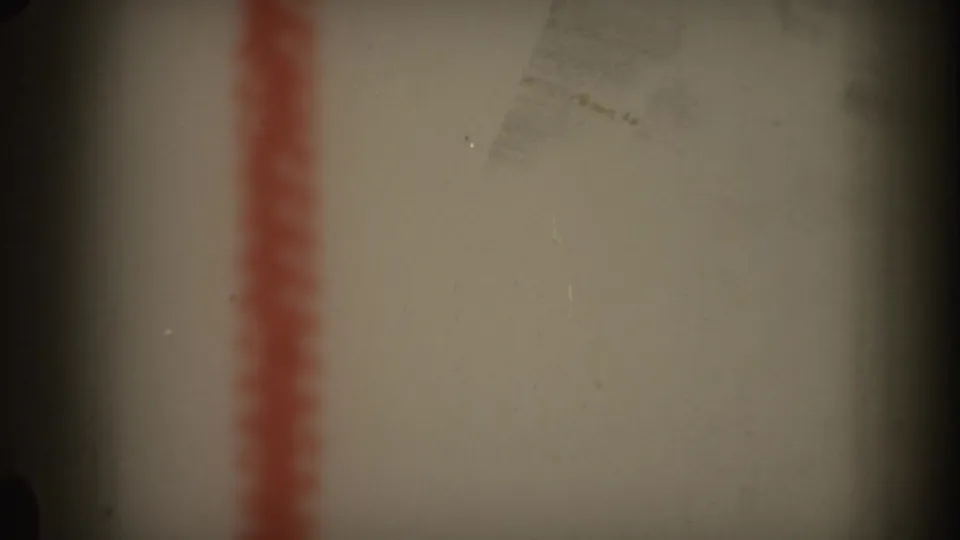 1969 Hawaii 8mm frame with a blurred red stripe, pale background, and a dark vertical shadow near the center.