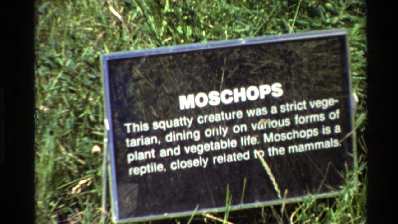 1980 8mm close-up of the Moschops sign describing the creature as vegetarian and related to mammals.