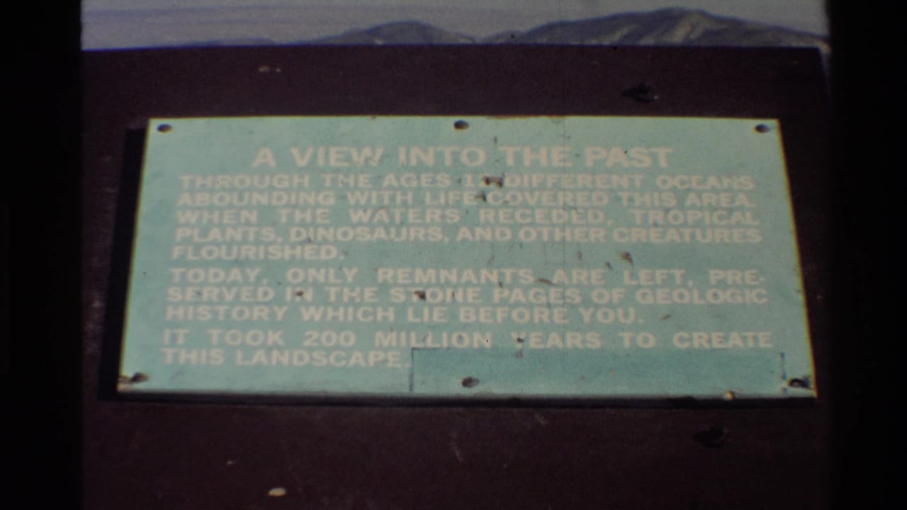 1980 Western USA 8mm still showing the pale green A VIEW INTO THE PAST sign, with soft focus and faded color.