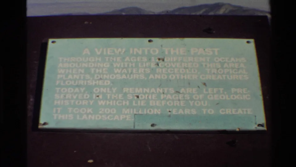 1980 Western USA 8mm still showing the pale green A VIEW INTO THE PAST sign, with soft focus and faded color.