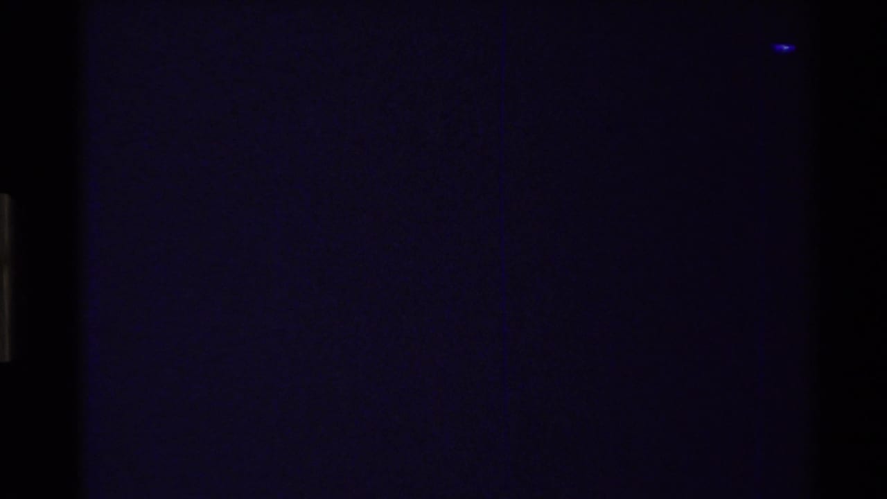Dark blue-purple frame with faint film texture and edge artifacts.
