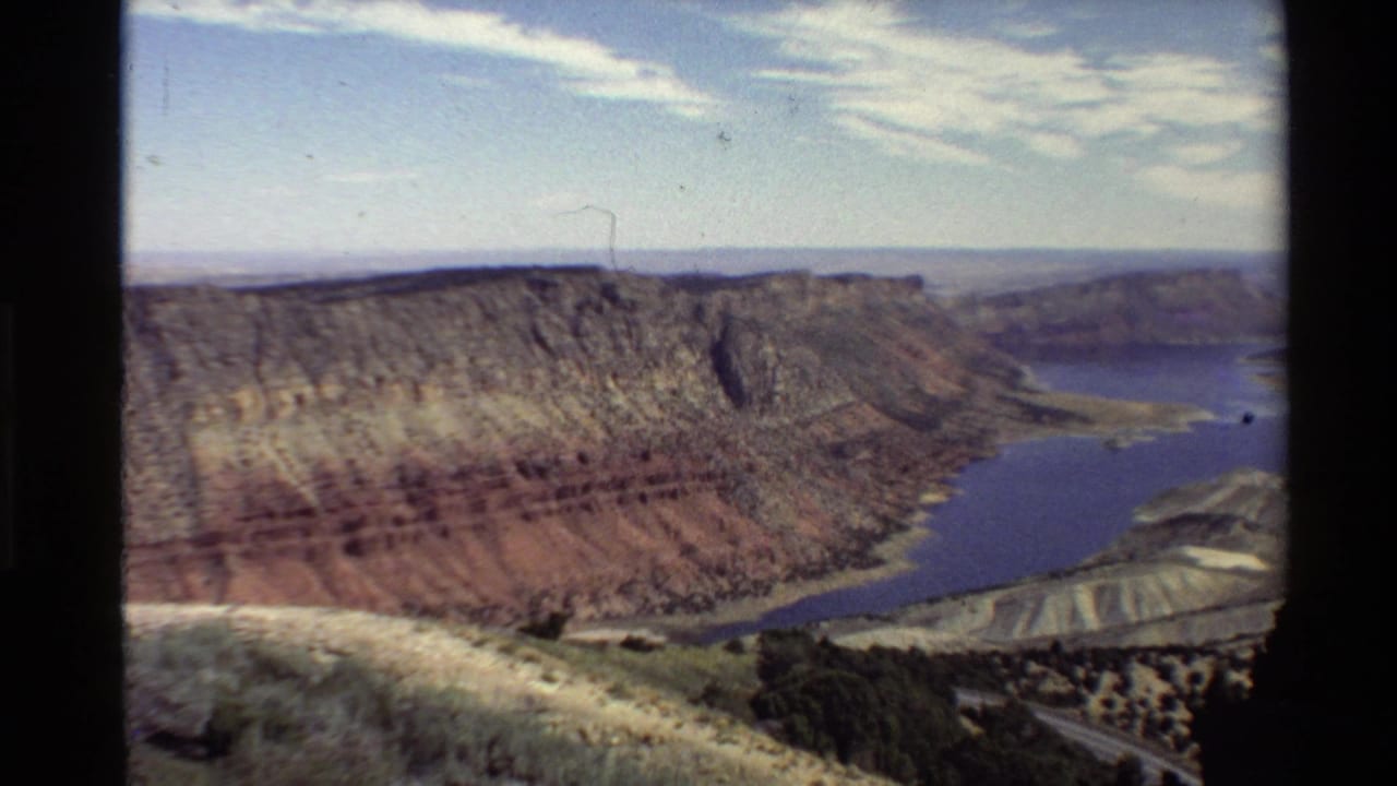 Wide canyon panorama with reservoir water curving along the canyon floor.