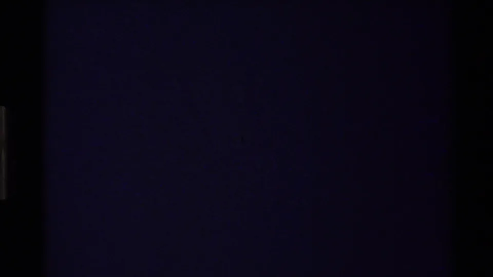 Dark end frame from the 8mm scan, suggesting the shot or reel has run out after the canyon river view.