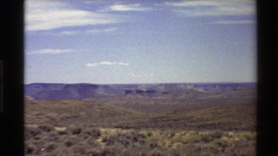 Wide 8mm view across arid western United States canyon terrain near Flaming Gorge, with scrub foreground and distant ridges.
