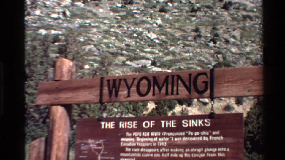 Close visitor view of Wyoming and Rise of the Sinks signage, filmed on 8mm with visible grain and soft focus.