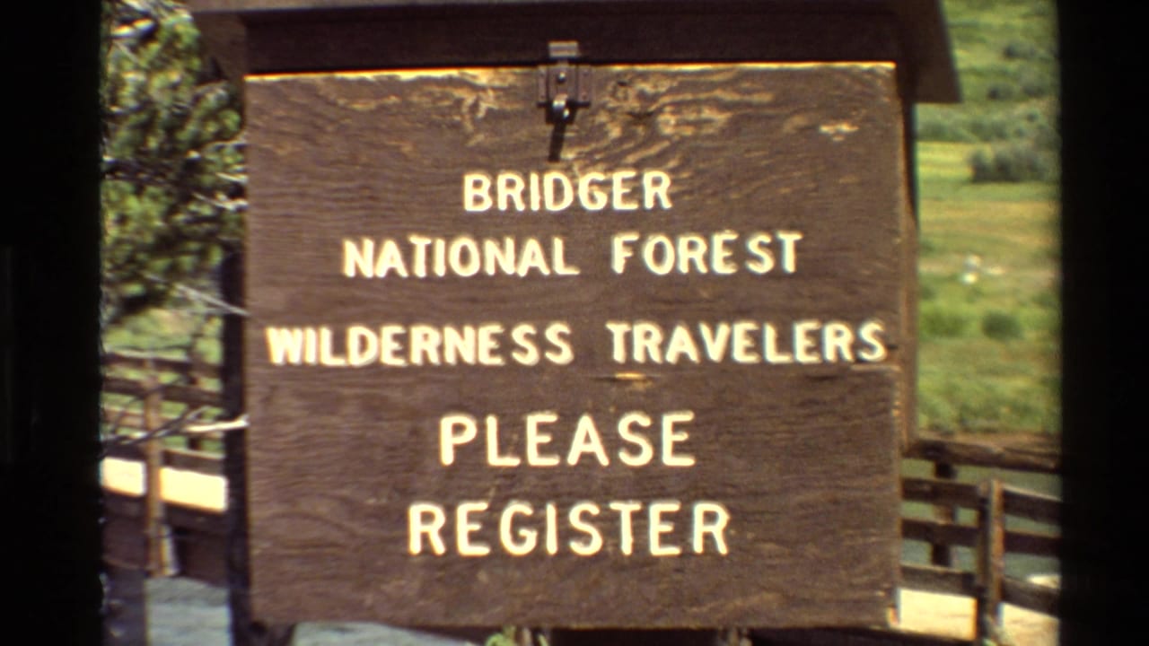 Wooden Bridger National Forest sign asking wilderness travelers to register.