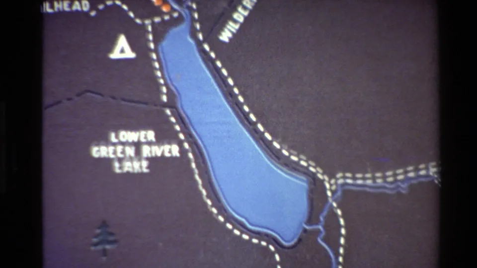 8mm frame of the map's lower section, showing Lower Green River Lake, dotted trail or boundary lines, blue water, and a small tree symbol.