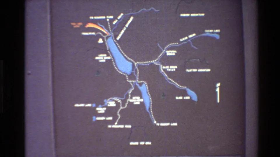 Final wide 8mm frame of the Western USA park map with blue lakes, dotted trails, white labels, and a compass arrow.