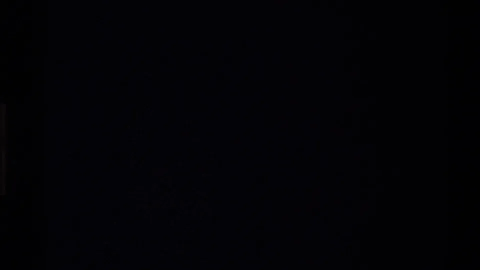 Dark 8mm frame from the start of a 1980 Western USA home-movie clip, with only faint film-edge shapes visible.
