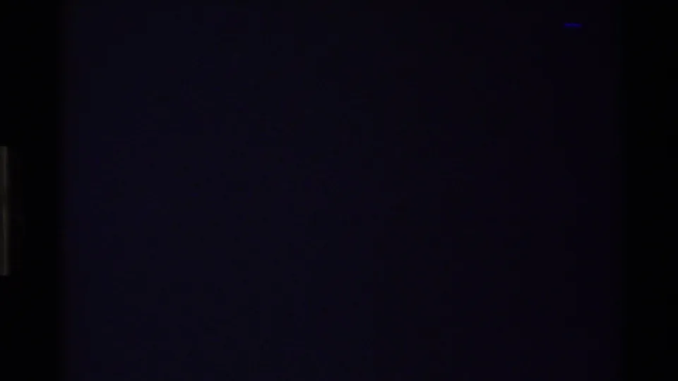 A second dark, blue-black 8mm frame with minimal detail, likely part of the transition before the mountain view.