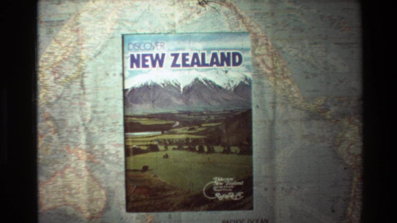 Travel guide cover centered on a map, showing New Zealand title and mountain landscape artwork.
