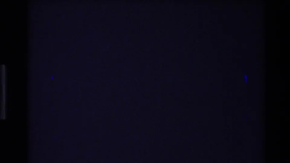 Dark 8mm transition frame with faint blue projection marks and visible gate edges.