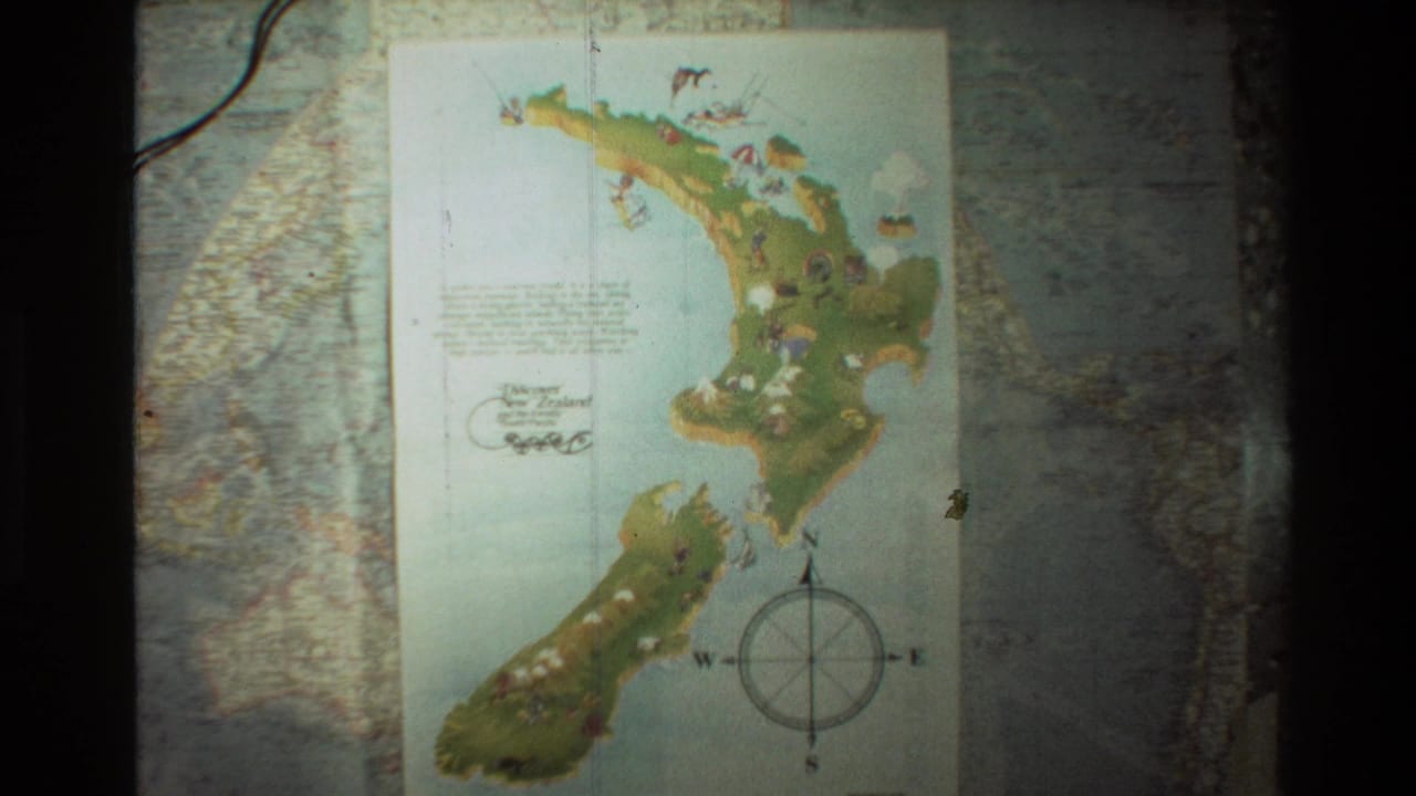 1981 8mm frame showing a colorful New Zealand map with a compass rose, set against a larger world map background.