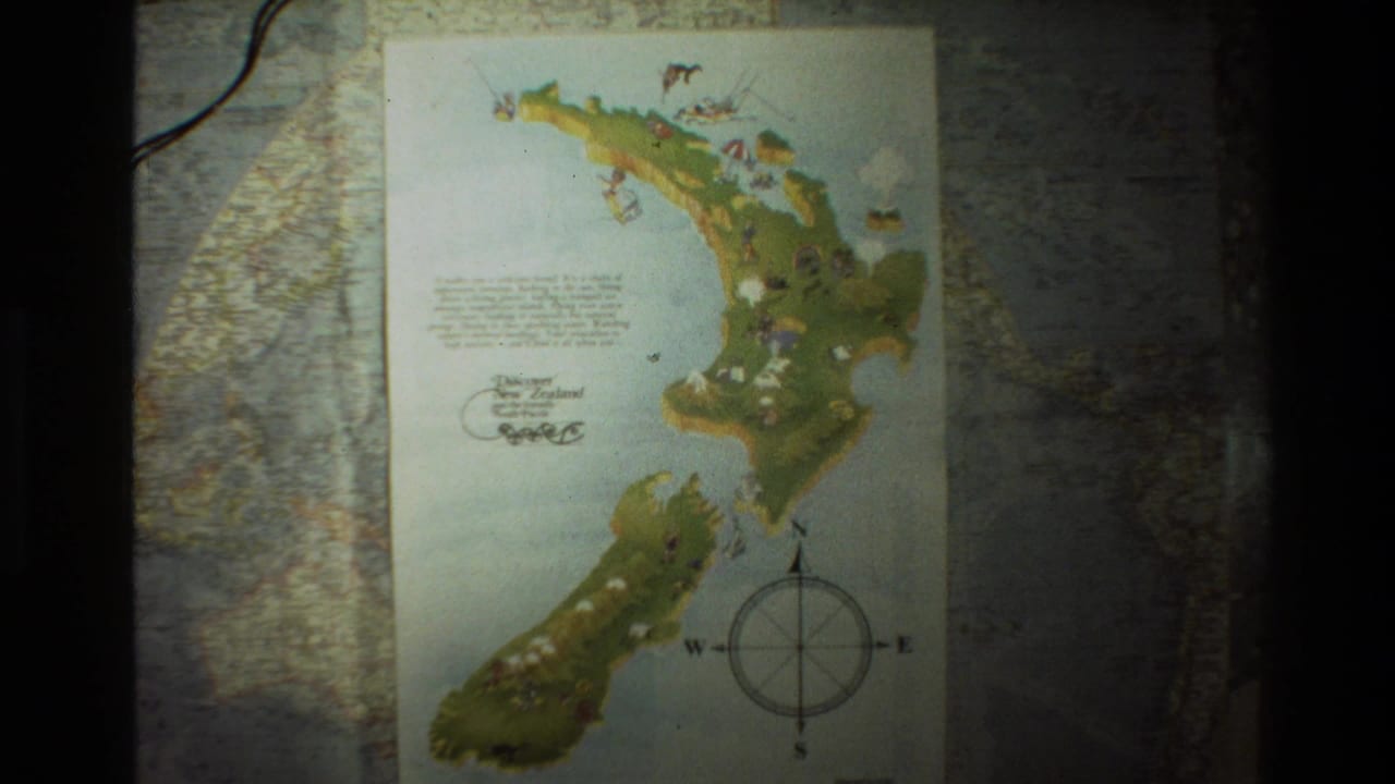 An illustrated map of New Zealand with a compass rose, seen in 1981 8mm travel footage from New Zealand.
