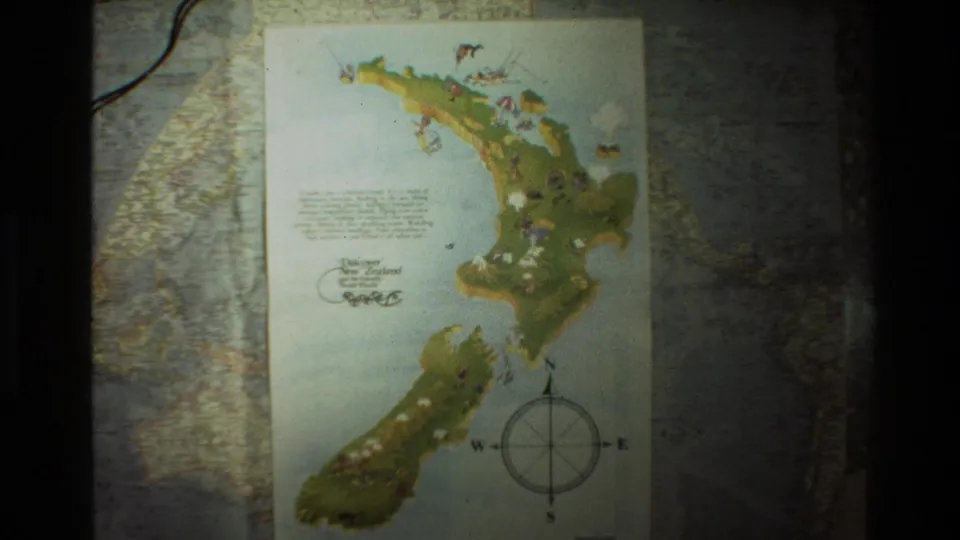 An illustrated map of New Zealand with a compass rose, seen in 1981 8mm travel footage from New Zealand.