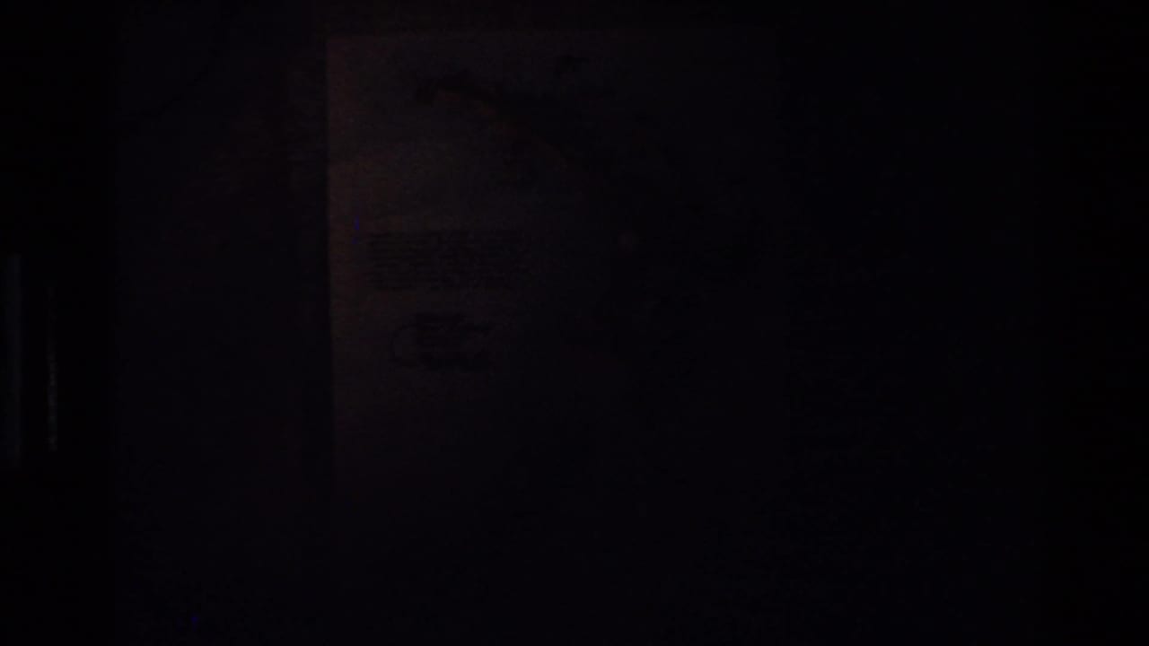 Dark, underexposed frame with a faint map shape and black vertical edge.