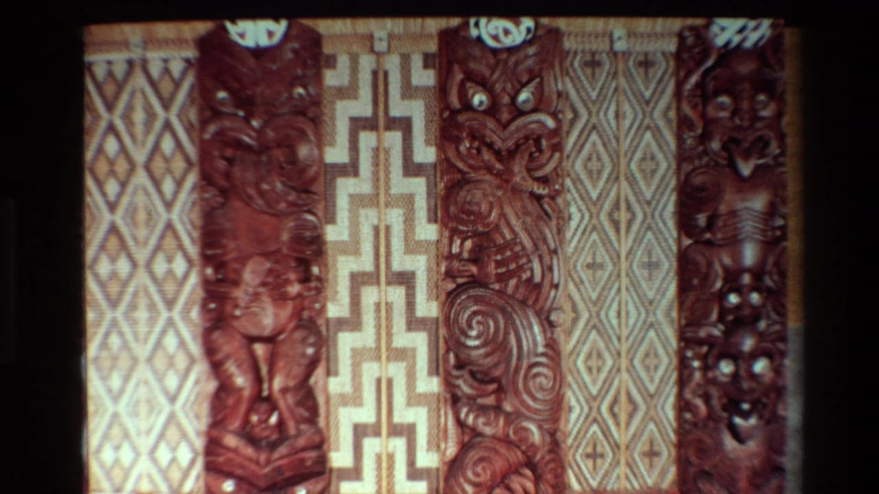 1981 New Zealand 8mm frame showing Maori carved wooden figures beside woven diamond and stepped-pattern wall panels.