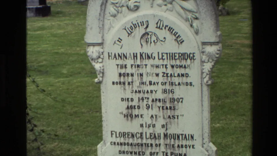 1981 New Zealand 8mm close-up of a weathered carved tombstone naming Hannah King Letheridge, set in grass with the inscription partly readable.