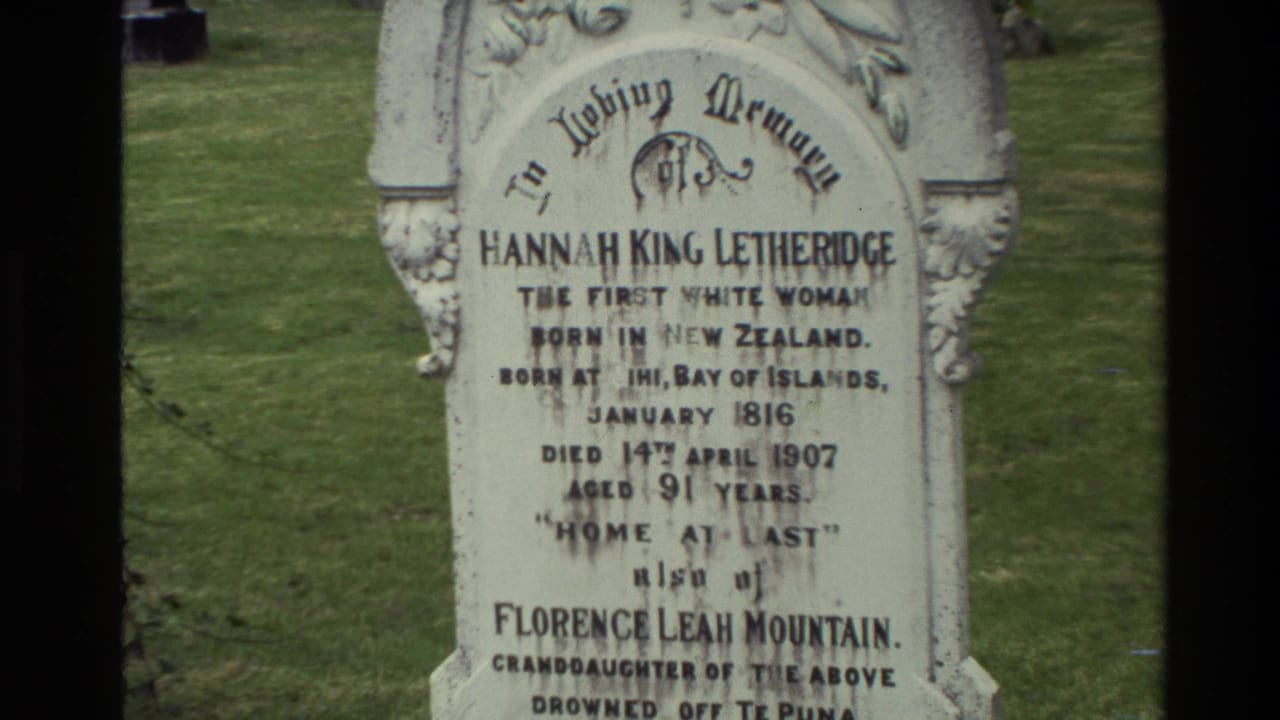 1981 New Zealand 8mm frame showing a white carved memorial stone for Hannah King Letheridge in a cemetery lawn.
