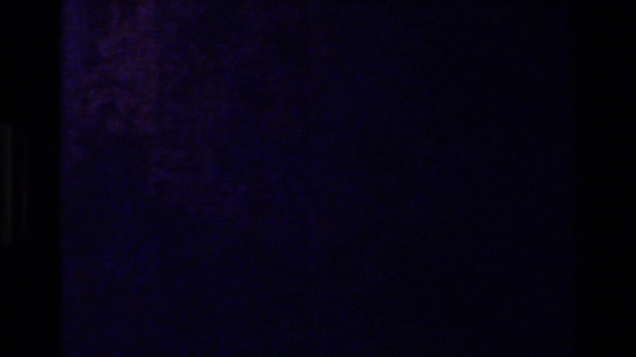 Mostly dark purple frame with faint texture and little visible detail.