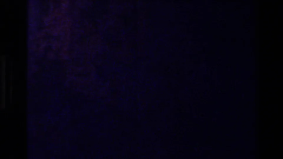 Dark 8mm frame with deep purple cast and faint surface texture, likely part of the transition between outdoor view and map.