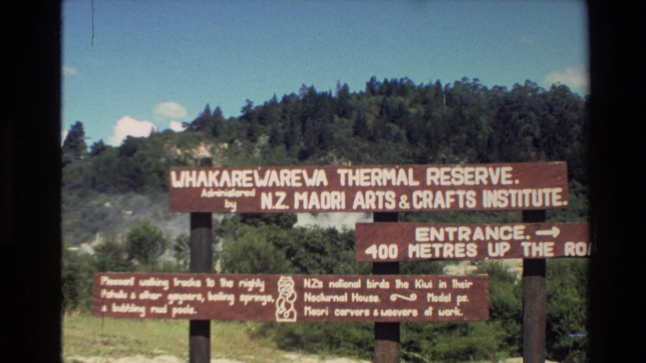 Wooden Whakarewarewa Thermal Reserve signage, administered by the N.Z. Maori Arts & Crafts Institute, seen in a visitor-shot 1981 frame.