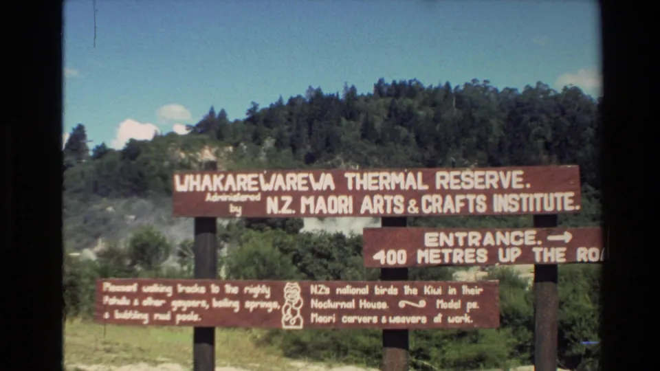 Wooden Whakarewarewa Thermal Reserve signage, administered by the N.Z. Maori Arts & Crafts Institute, seen in a visitor-shot 1981 frame.