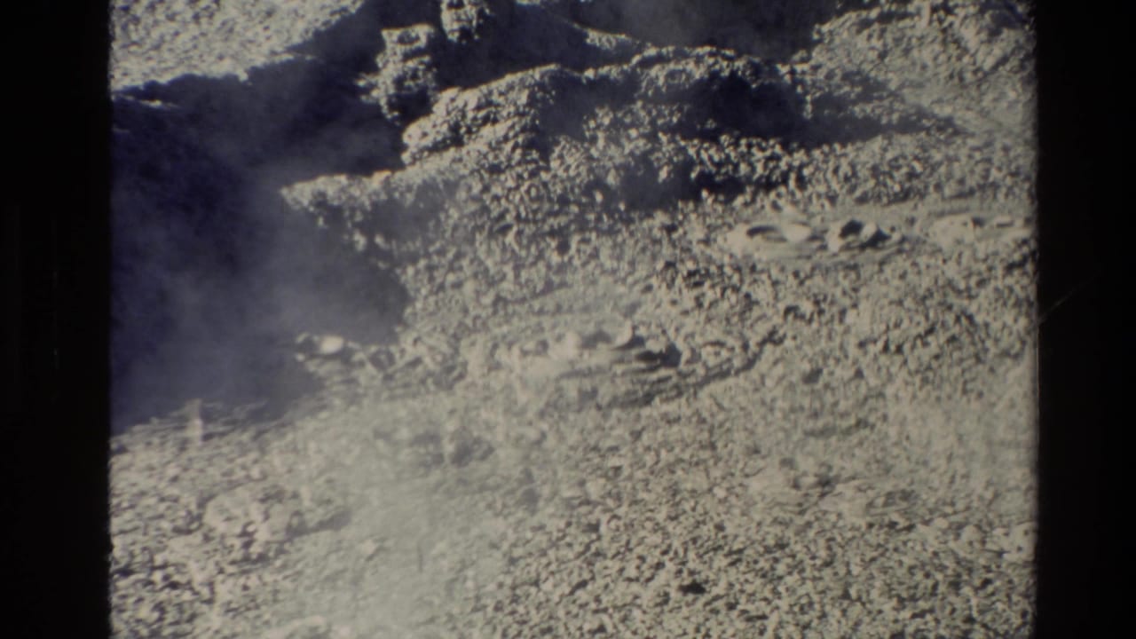 1981 New Zealand 8mm frame showing steam rising over rough geothermal ground and light-toned mineral deposits.