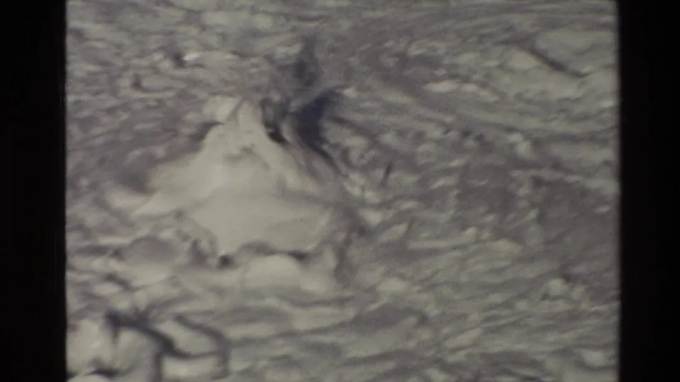 1981 New Zealand 8mm frame showing a pale boiling mud formation, with soft focus and archive film border visible.