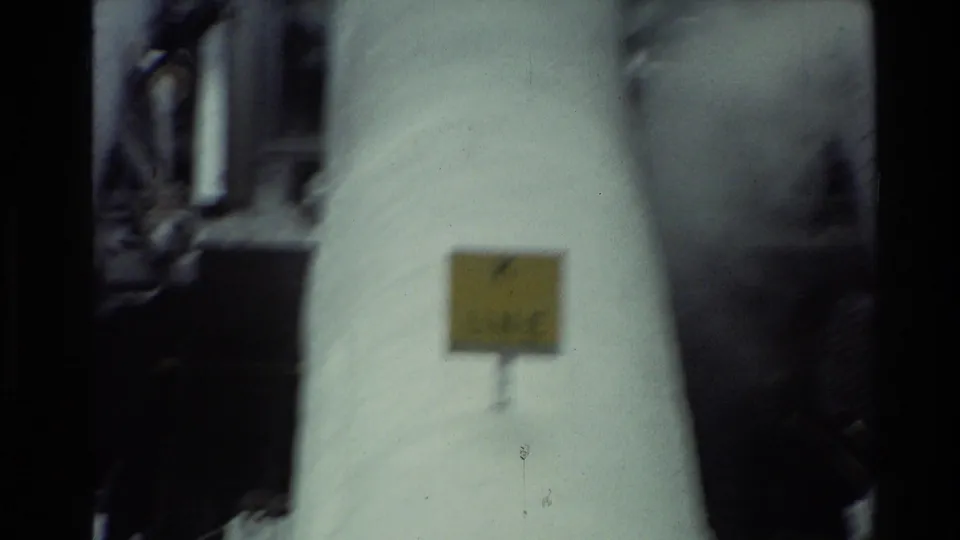 Close 8mm view of a white industrial pipe in New Zealand, showing a small yellow label that appears to read K LINE.