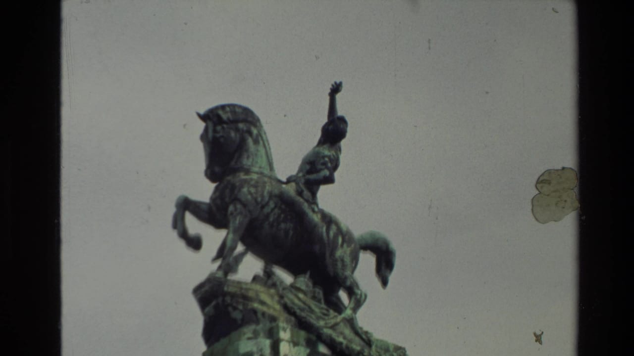 Bronze equestrian statue with a rider on a rearing horse against the sky.