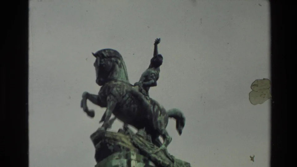 Close view of a green-patina equestrian statue in New Zealand, with the rider and rearing horse silhouetted against a pale sky.