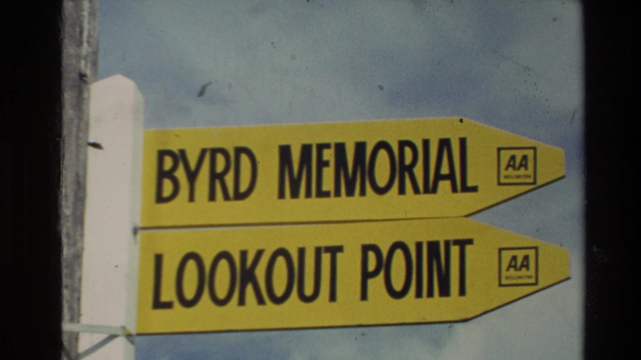 Yellow Byrd Memorial and Lookout Point directional sign against blue sky.