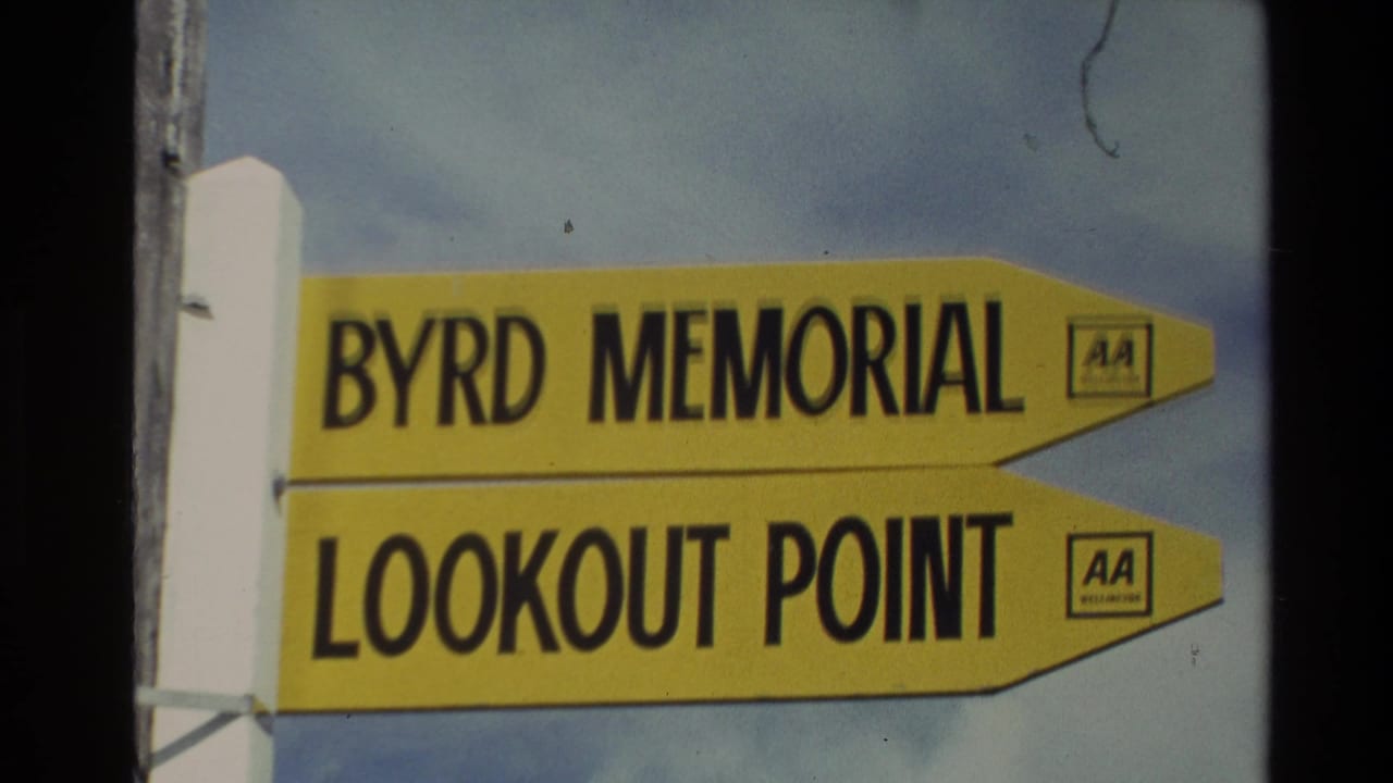 Close 8mm view of a yellow New Zealand viewpoint sign for Byrd Memorial and Lookout Point with visible AA branding.
