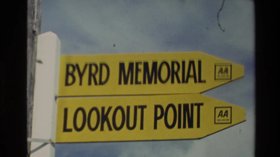 Close 8mm view of a yellow New Zealand viewpoint sign for Byrd Memorial and Lookout Point with visible AA branding.