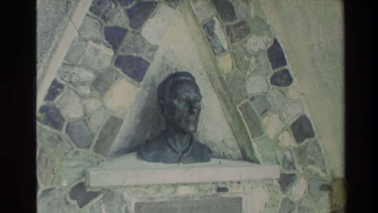 Home-movie view of a bust-like sculpture with a stone mosaic surround, likely filmed during a New Zealand visit in 1981.