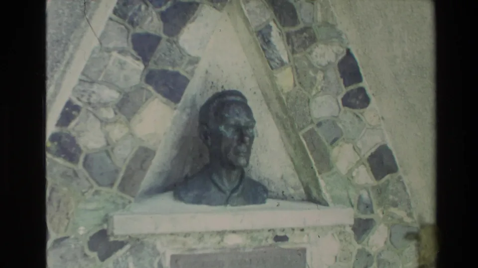 Home-movie view of a bust-like sculpture with a stone mosaic surround, likely filmed during a New Zealand visit in 1981.