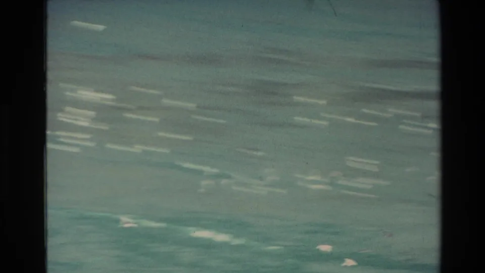 Soft 8mm frame of turquoise water in New Zealand, with motion-blurred white streaks and no people or landmarks visible.